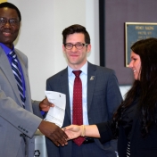 Tom Otieno and Andrew Polter accept check from Novelis rep, Tammy Peyton