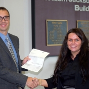 Patrick McKee accepts check from Novelis rep, Tammy Peyton