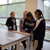 Students clamp board to desk for an earthquake activity