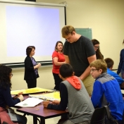 Graduate student, Zachary Morgan leads students in probability games