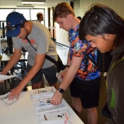 Model Lab students look at literature provided by the EKU Gaming Institute