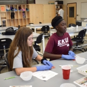 Two young women from Model Lab school work on a biology experiment