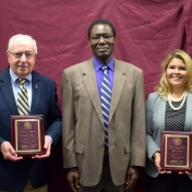 Award Recipients Donald Whitaker and Erika Gil Winter pose with Dr. Otieno