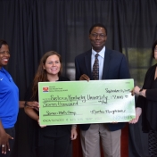 Monica Johnson and Tammy Peyton pose with Tom Otieno and Karin Sehemann