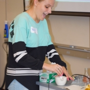 Madison Southern students grinds a banana with a mortar and pestle.