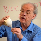 Dr. Martin Brock pours a mashed banana solution into a test tube.